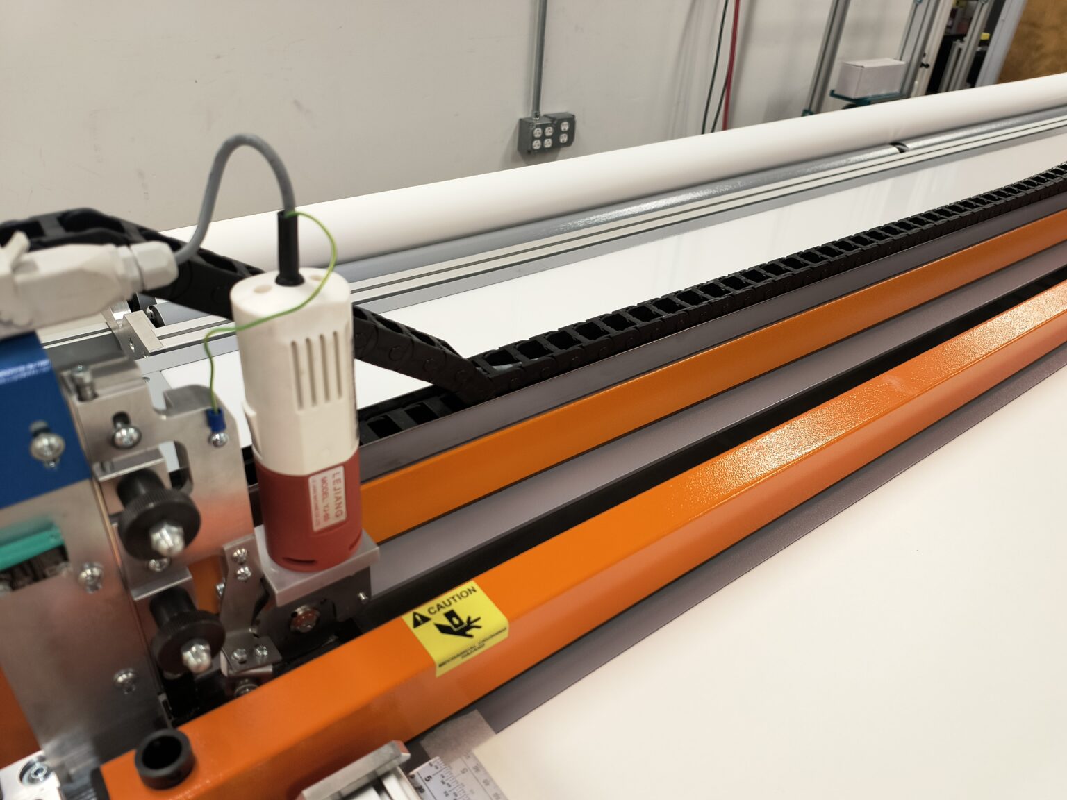 Cutting machine used to trim roller shade fabric with precision in NYC workshop