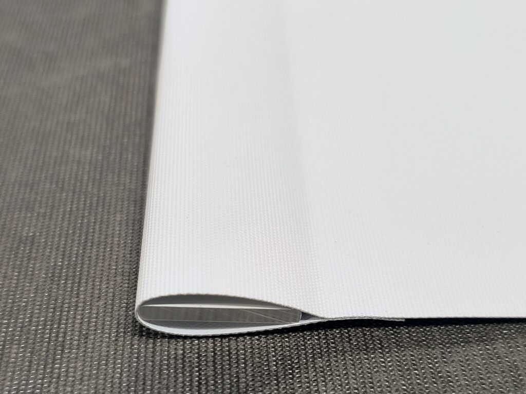 Custom roller shade fabric replacement kit with precision-cut fabric, aluminum hem bar, double-sided tape, and installation instructions.