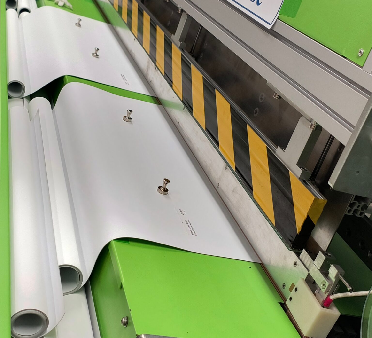 Custom roller shade fabric being precision‑cut and welded for nationwide shipping.
