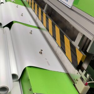 Custom roller shade fabric being precision‑cut and welded for nationwide shipping.