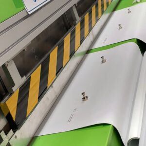 Custom roller shade fabric being precision‑cut and welded for nationwide shipping.