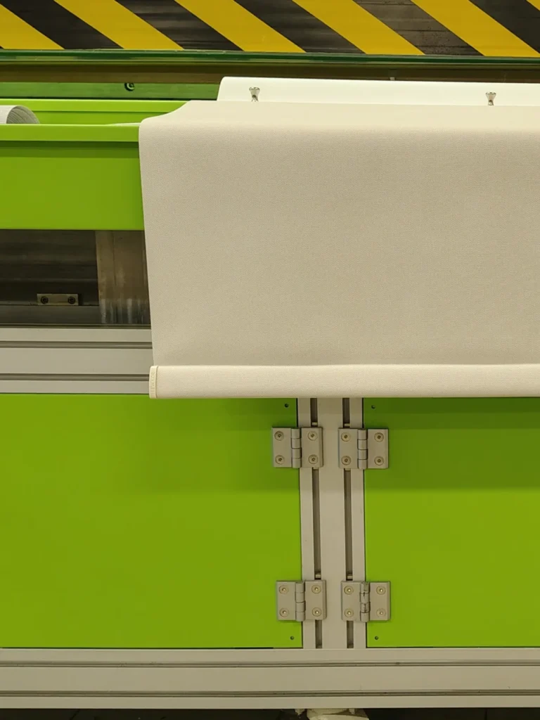 Roller shade fabric with wrapped hem bar during fabrication