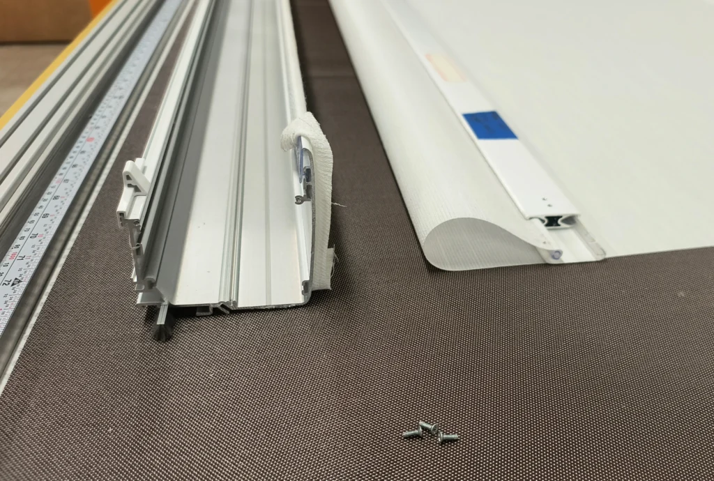 Roller shade side channels and replacement fabric prepared for installation