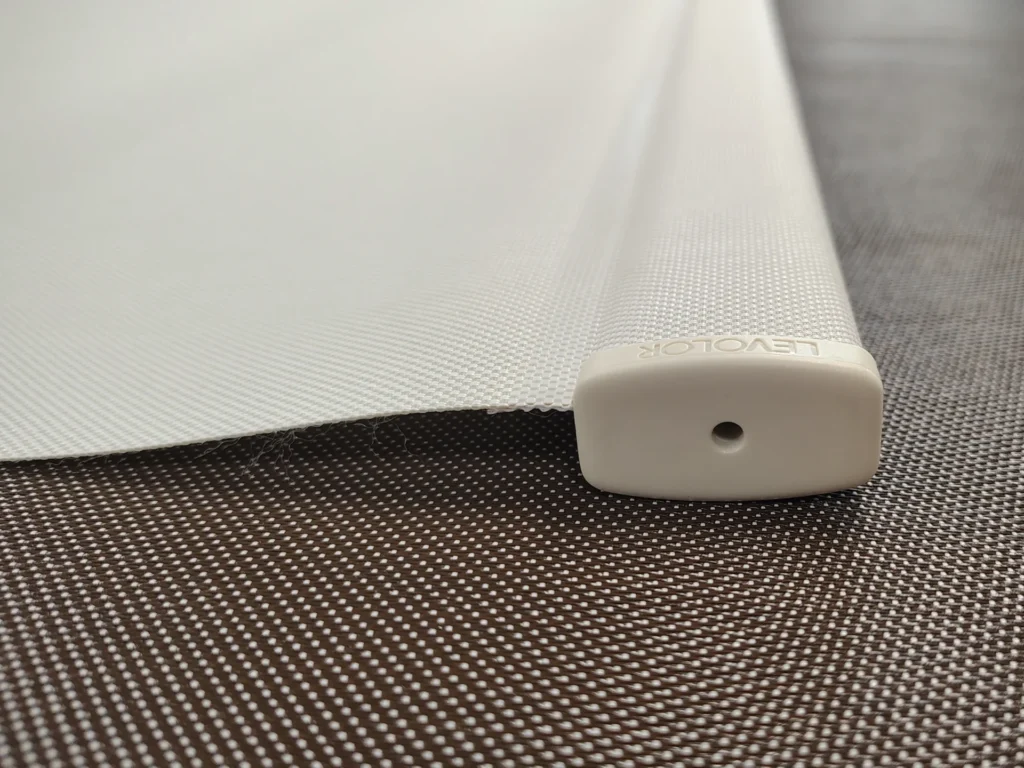 Close-up of roller shade fabric wrapped around bottom hem bar